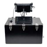 Black metal box with a mechanical arm and screen on a white background