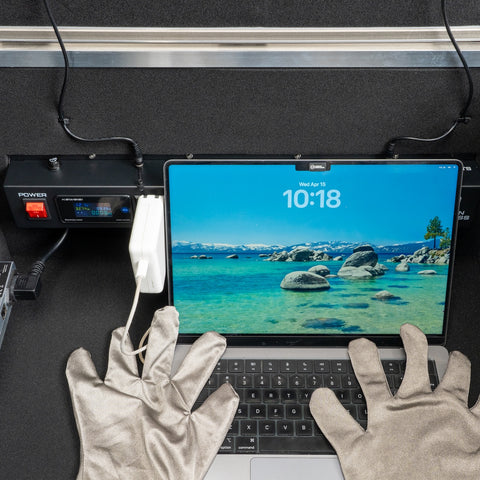 Laptop and gloved hands inside the spacious BlockBox Lab XL interior