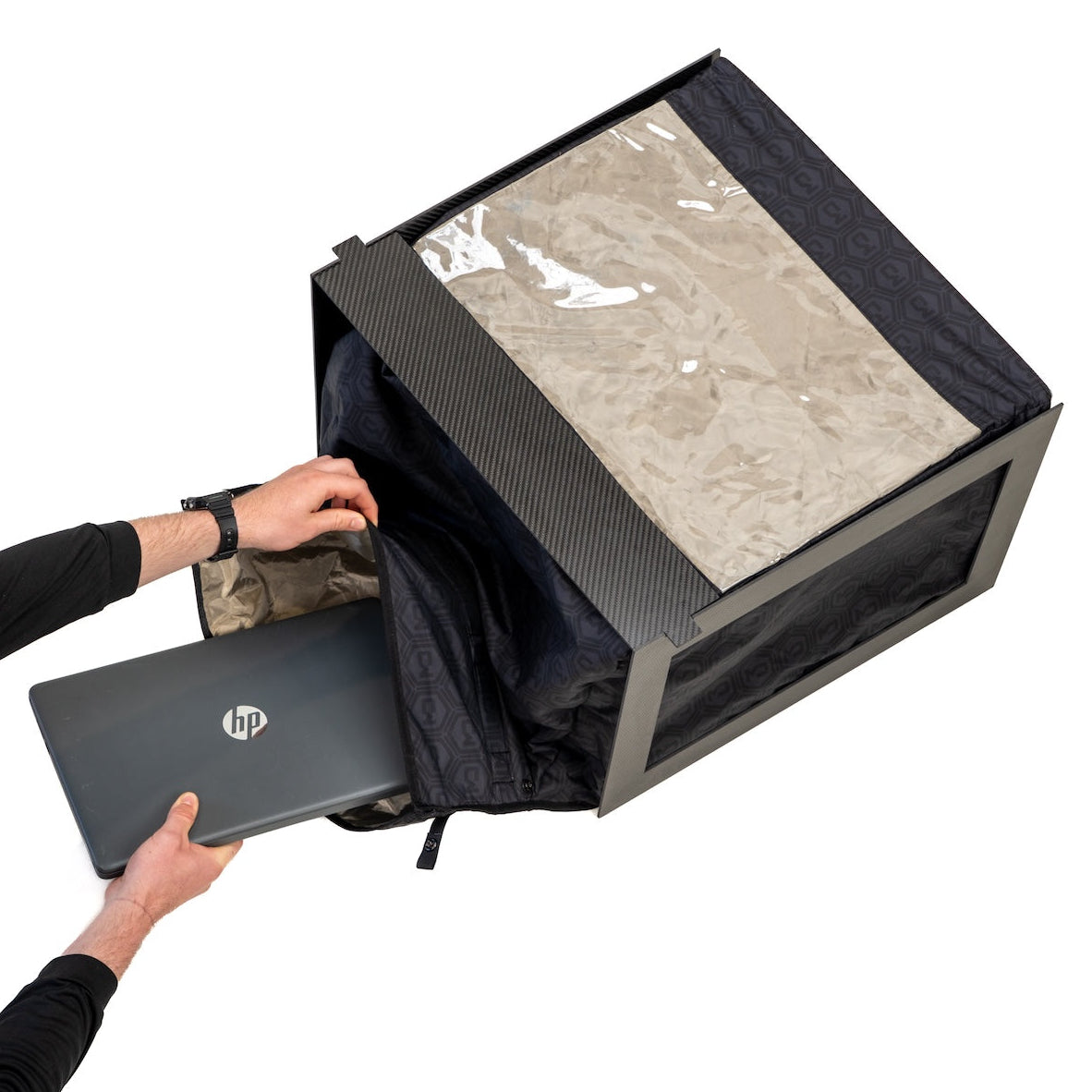Operator lowering a laptop into the BlockBox Touch Pro through its wide magnetic opening