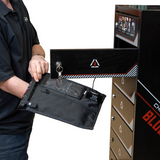 Person holding a black bag with a logo next to a large black locker labeled 'Blocker Lock'.