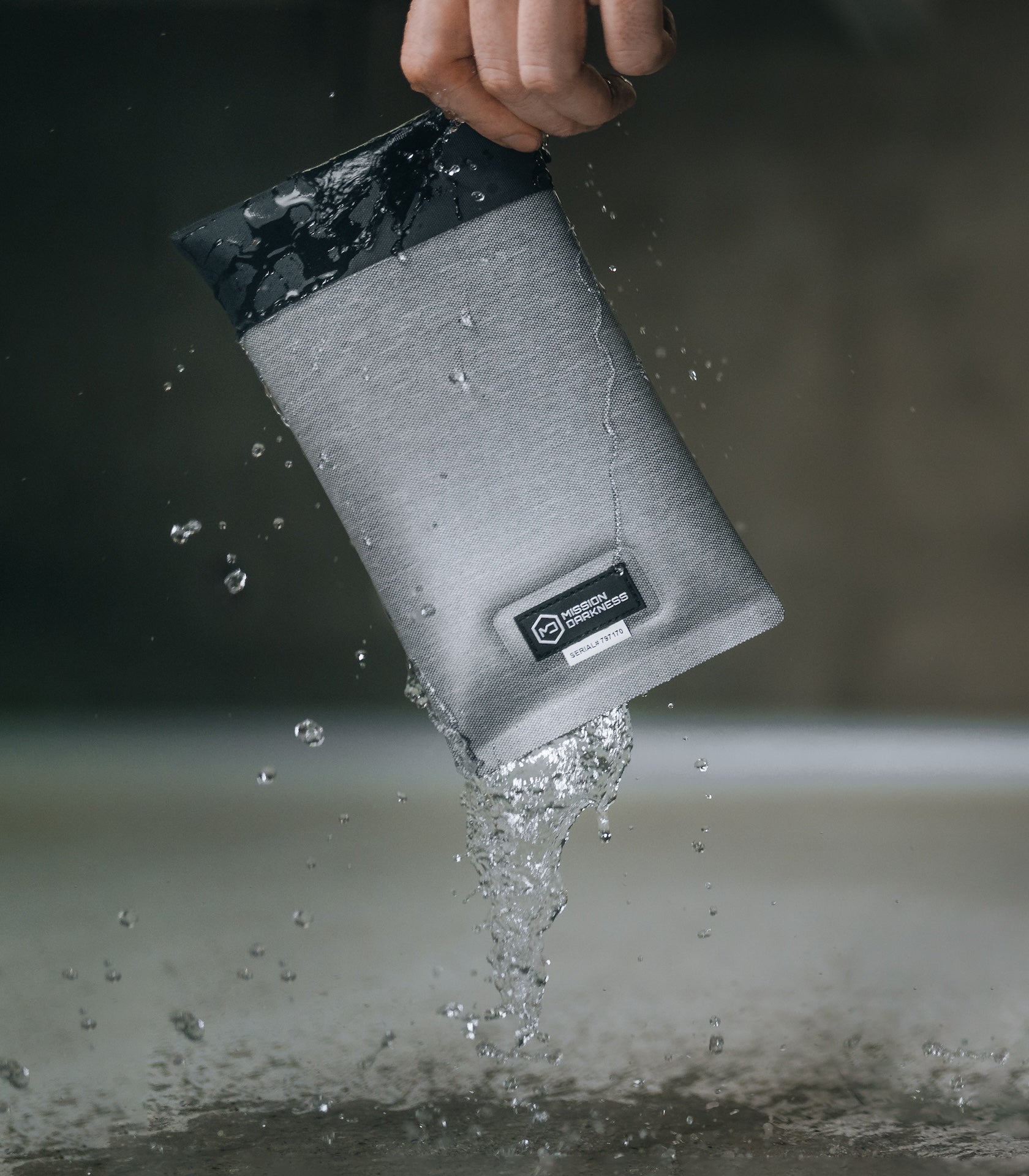 Water pouring off the sealed Dry Shield Faraday Phone Sleeve