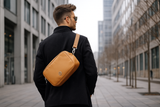 man wearing velaria crossbody purse city background