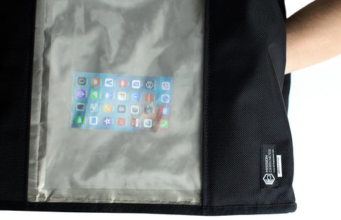 Top-down view of a phone placed inside the open BlockBox Touch chamber
