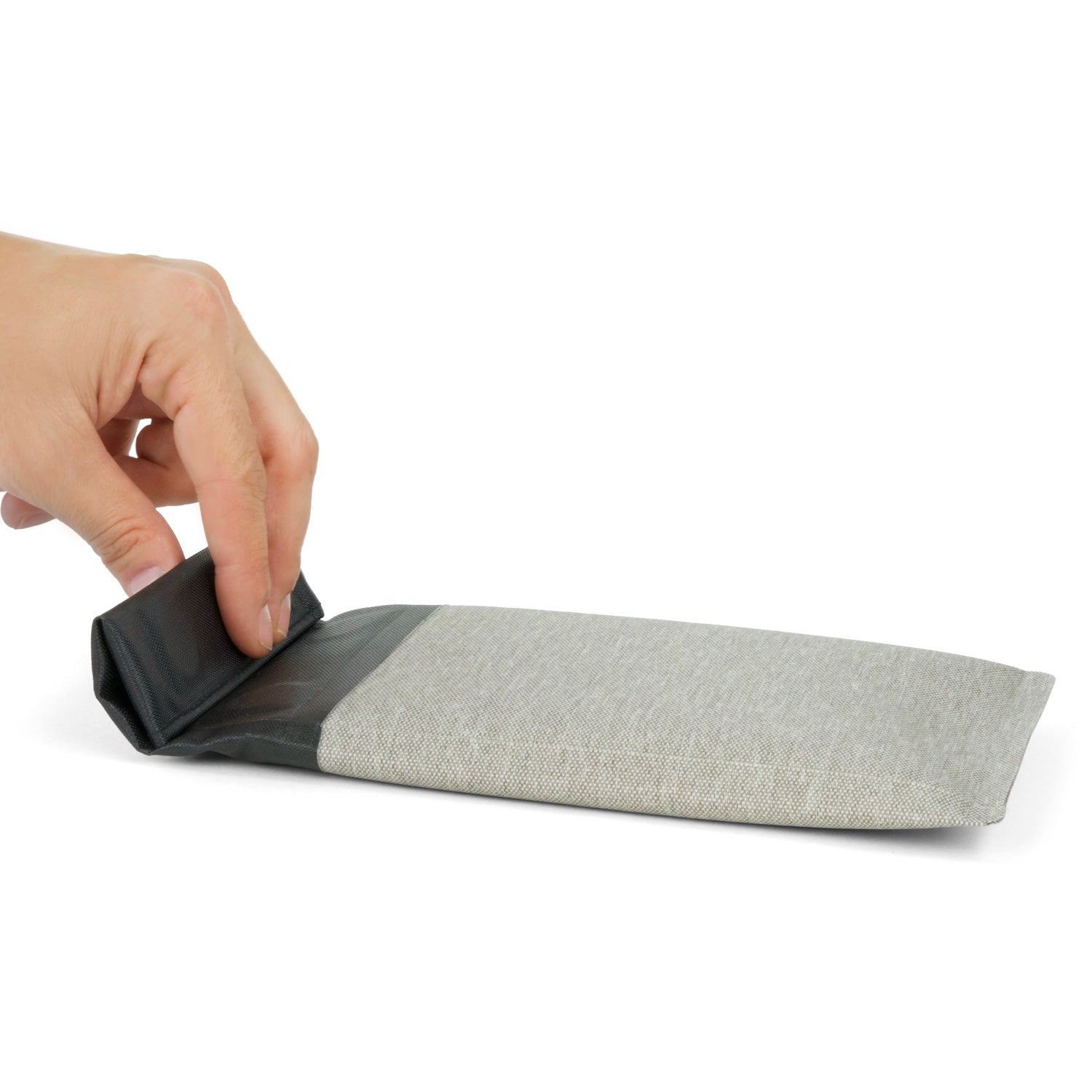 Hand rolling down the top flap of the Dry Shield Faraday Phone Sleeve to seal it